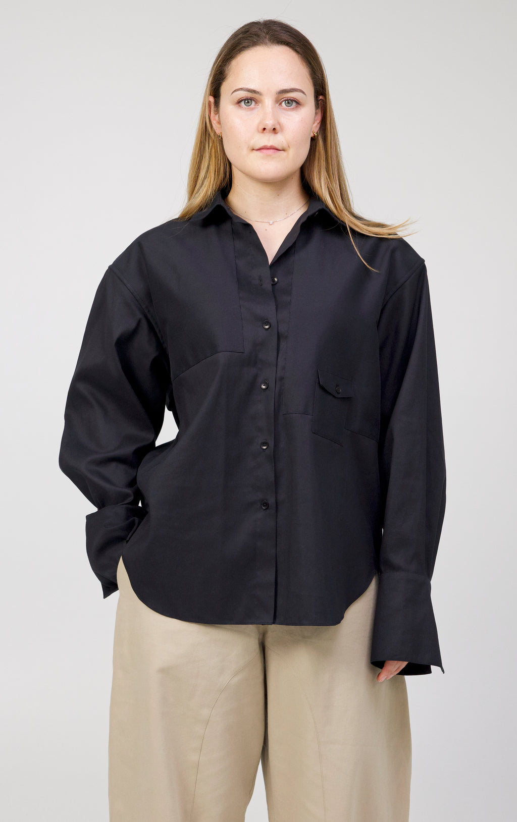 Black Storm shirt in cotton and silk worn with beige trousers, front view